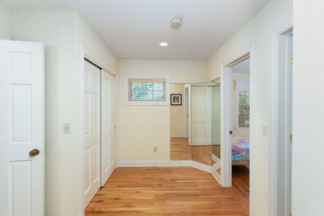 corridor with light hardwood / wood-style floors