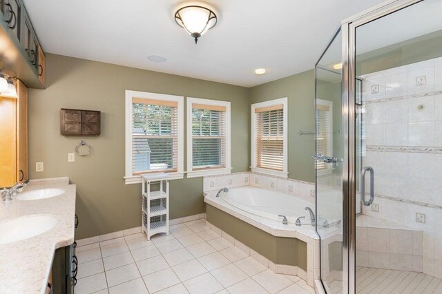 513 Rockhill Rd, Columbia, MO 65201 - bathroom with a garden tub, double vanity, a stall shower, and tile patterned flooring