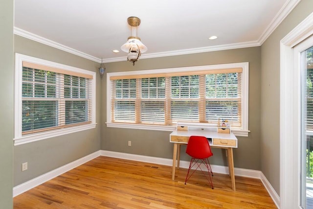 office area with light hardwood / wood-style floors and crown molding