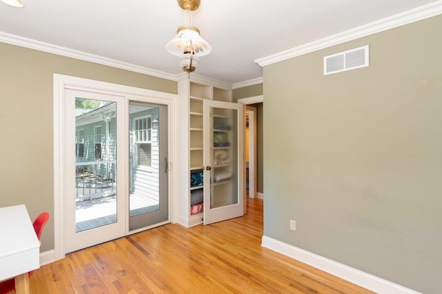 entryway featuring light hardwood / wood-style flooring, crown molding, and french doors