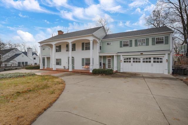 view of front facade with a front lawn, a porch, and a garage