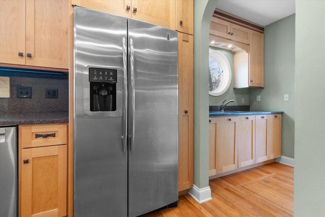 513 Rockhill Rd, Columbia, MO 65201 - kitchen featuring appliances with stainless steel finishes, light wood-style flooring, light brown cabinets, and dark countertops