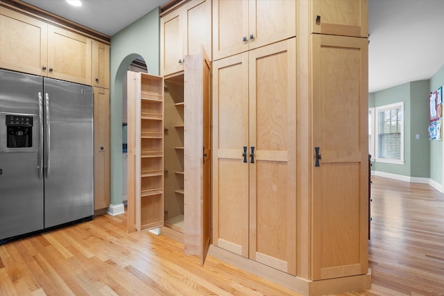 513 Rockhill Rd, Columbia, MO 65201 - kitchen featuring stainless steel fridge, light wood-style floors, arched walkways, and light brown cabinetry