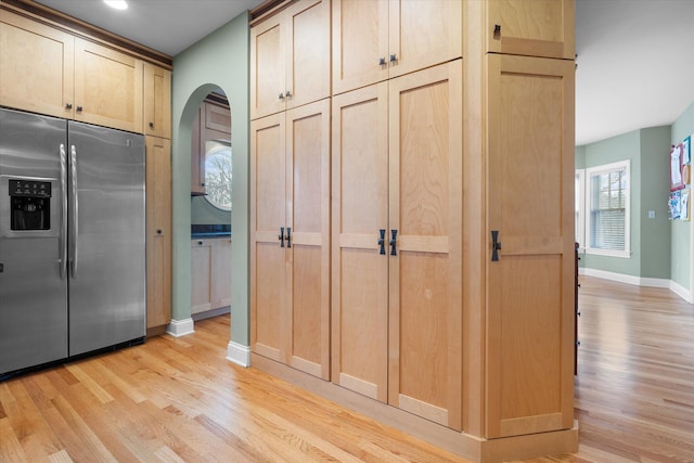 513 Rockhill Rd, Columbia, MO 65201 - kitchen with stainless steel refrigerator with ice dispenser, light wood finished floors, arched walkways, and light brown cabinetry