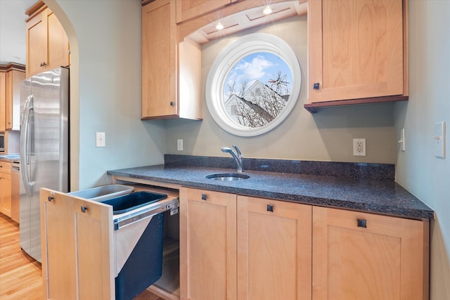 513 Rockhill Rd, Columbia, MO 65201 - kitchen featuring freestanding refrigerator, light brown cabinetry, arched walkways, and light wood-style floors
