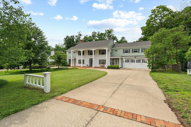 513 Rockhill Rd, Columbia, MO 65201 - neoclassical / greek revival house featuring a porch, concrete driveway, a chimney, a shingled roof, and an attached garage