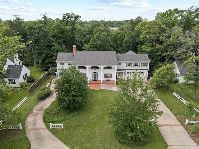 513 Rockhill Rd, Columbia, MO 65201 - view of front facade featuring covered porch, a shingled roof, concrete driveway, a front yard, and a chimney