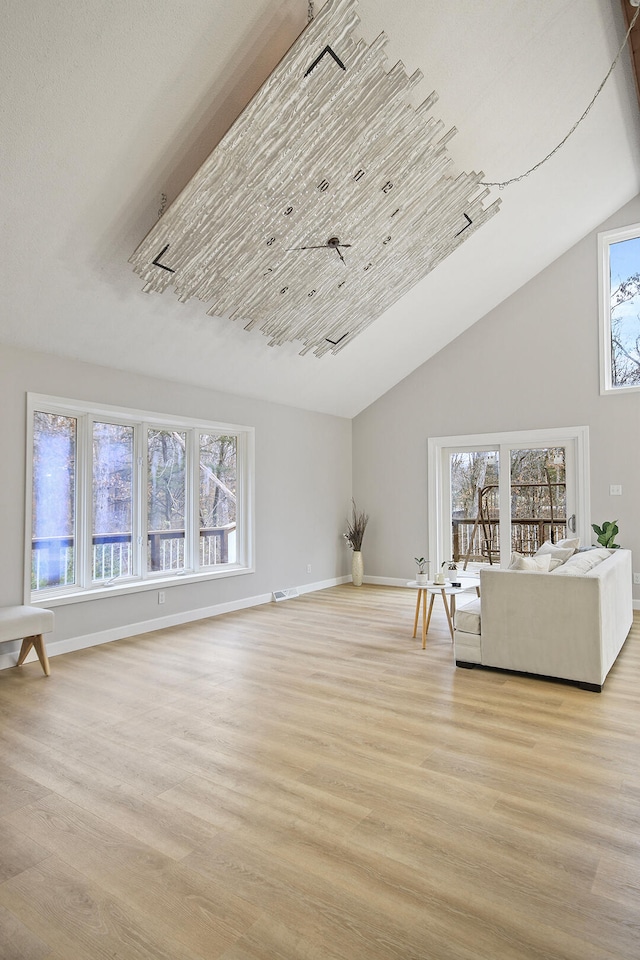 unfurnished living room featuring a wealth of natural light and light hardwood / wood-style flooring