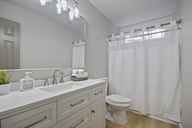 bathroom featuring hardwood / wood-style floors, vanity, and toilet