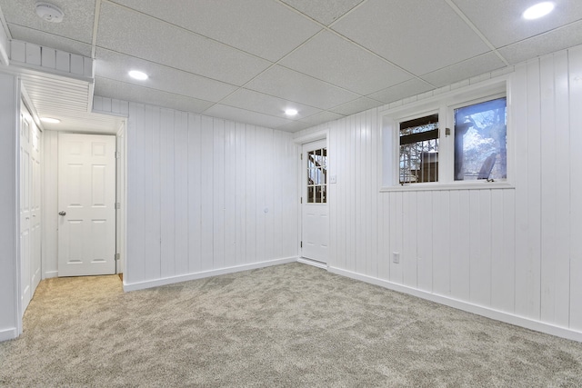 spare room with light carpet and a drop ceiling