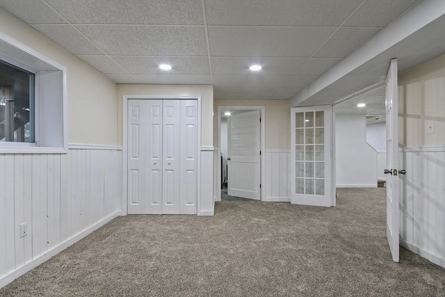 unfurnished bedroom featuring carpet floors and a paneled ceiling