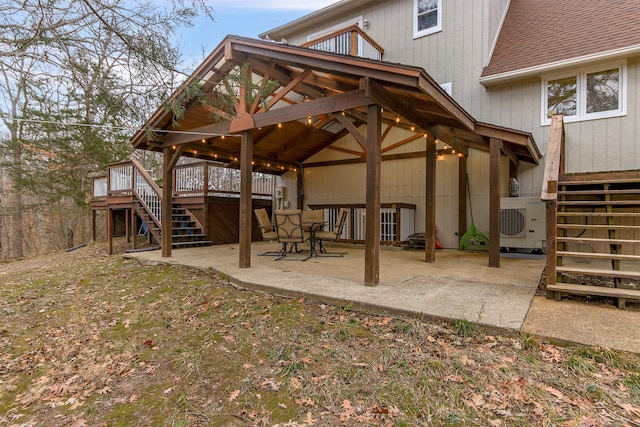 view of patio with ac unit and a deck