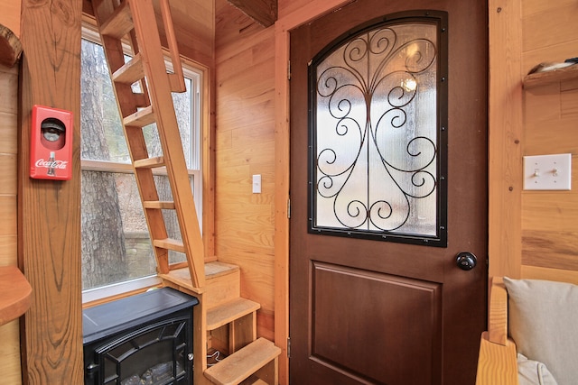 entryway featuring wooden walls