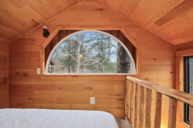 unfurnished bedroom featuring lofted ceiling, wood walls, and wooden ceiling