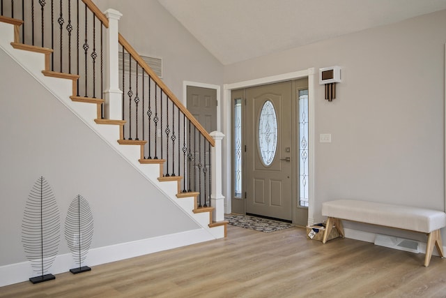 entrance foyer featuring vaulted ceiling and light wood-type flooring