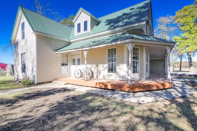 back of house featuring covered porch