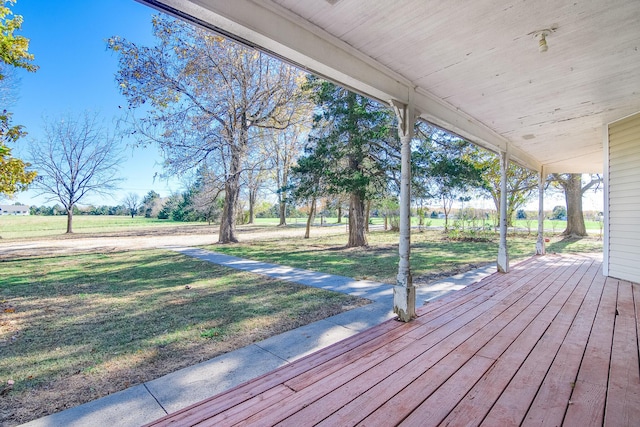 deck with covered porch and a lawn