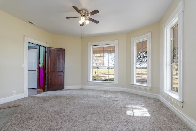 carpeted empty room featuring ceiling fan