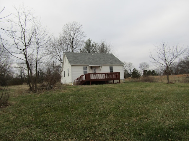 back of property with a lawn and a deck