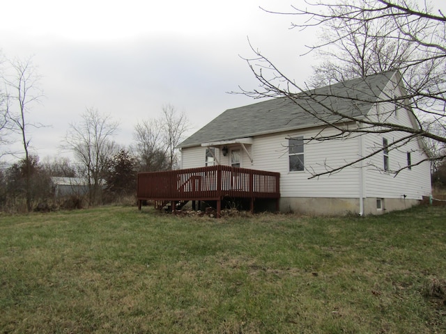 rear view of property with a yard and a wooden deck