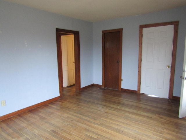 unfurnished bedroom with wood-type flooring