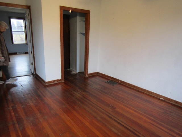 spare room with dark wood-type flooring