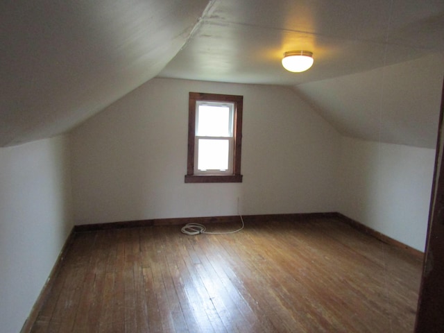 bonus room with hardwood / wood-style floors and lofted ceiling