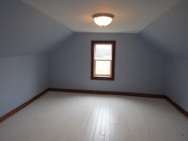 additional living space featuring vaulted ceiling