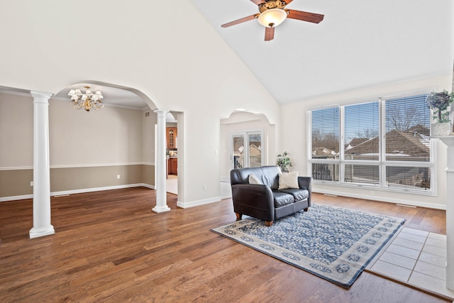 sitting room featuring high vaulted ceiling, wood-type flooring, and ceiling fan with notable chandelier