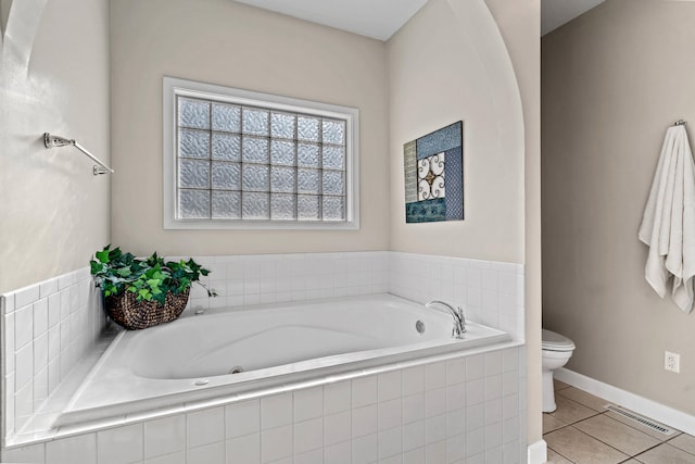 bathroom featuring tile patterned flooring, visible vents, a garden tub, and toilet