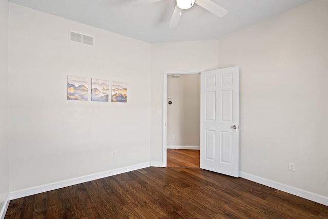 empty room featuring baseboards, dark wood finished floors, visible vents, and a ceiling fan