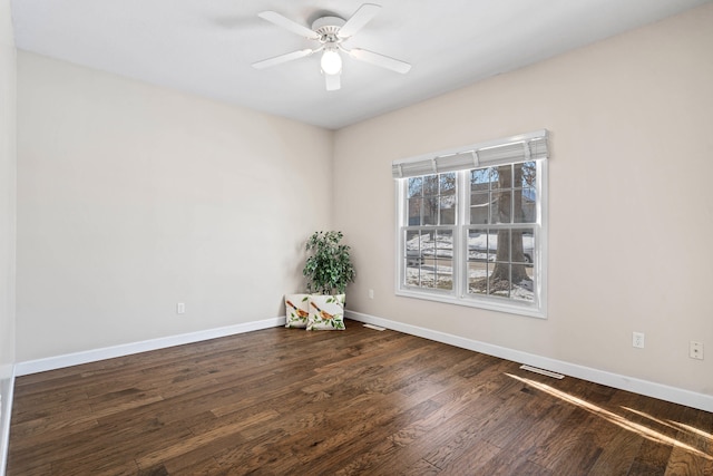 unfurnished room featuring ceiling fan, visible vents, baseboards, and wood finished floors