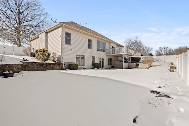 snow covered property featuring a deck