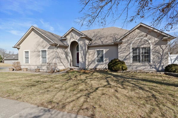 view of front of property with a front lawn and stucco siding