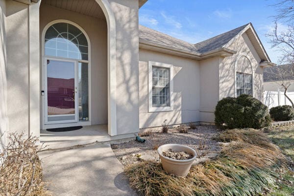 entrance to property with stucco siding