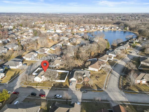 drone / aerial view with a water view and a residential view