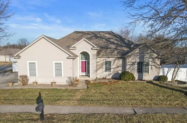 view of front of property with a front lawn and stucco siding