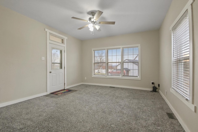 spare room with carpet flooring and ceiling fan