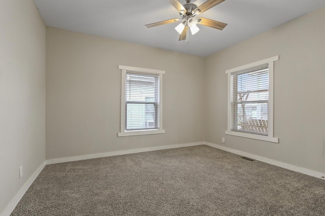 carpeted spare room featuring ceiling fan