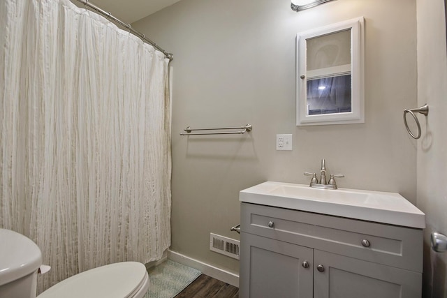 bathroom featuring hardwood / wood-style floors, vanity, and toilet