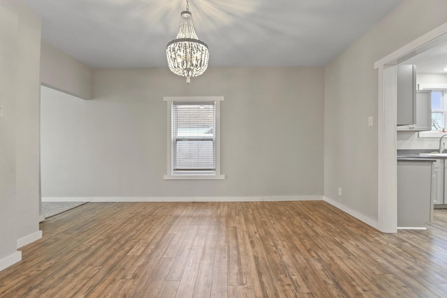 interior space with hardwood / wood-style flooring, a notable chandelier, and sink