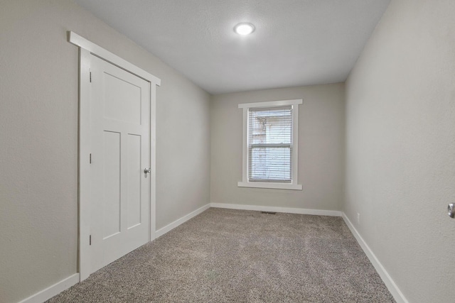 spare room featuring carpet flooring