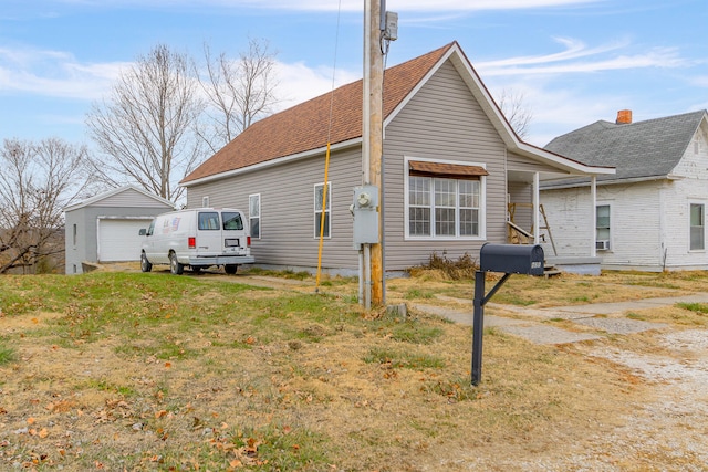 view of side of property with a garage and an outdoor structure