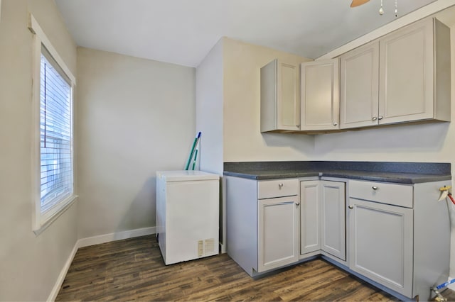 kitchen featuring dark hardwood / wood-style floors, fridge, and ceiling fan