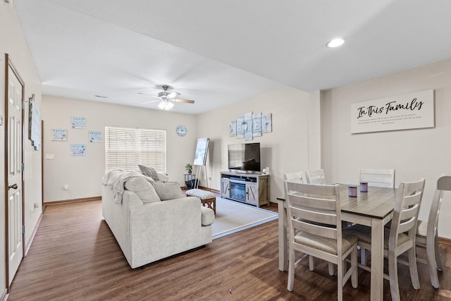 living room with dark hardwood / wood-style flooring and ceiling fan