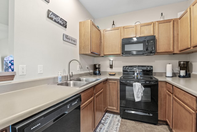 kitchen featuring black appliances, light tile patterned floors, and sink