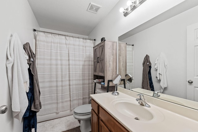 full bathroom with vanity, shower / bath combo, and toilet