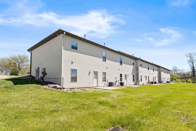 rear view of property with a patio area, a yard, and central air condition unit