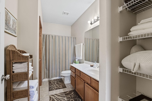 bathroom featuring tile patterned floors, vanity, and toilet