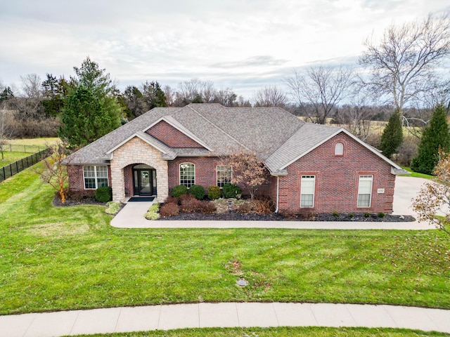 ranch-style home featuring a front yard